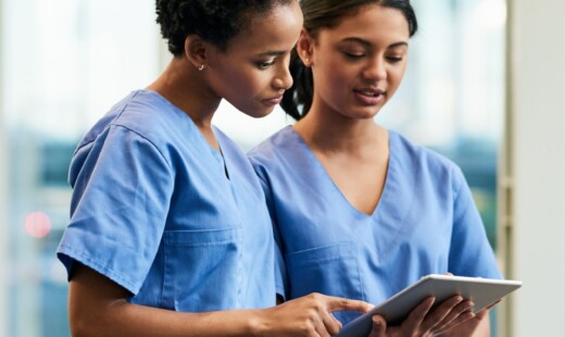 Nurses looking at tablet for nursing apps