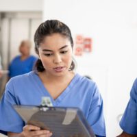 Quality assurance nurse checking patient chart