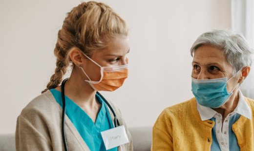 Nurse relaying care plan to patient on tablet