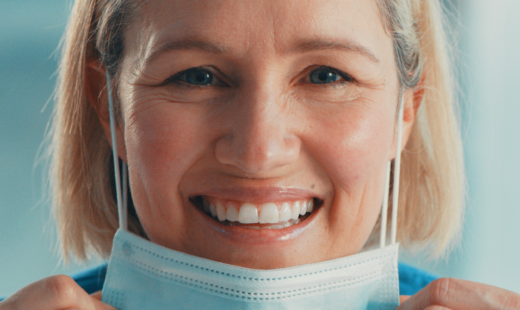 Nurse smiling with no skin complications when taking off ppe face mask